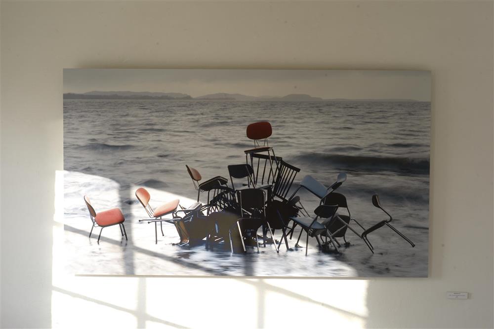 Fotografi av stoler stabla i sjøen - Klikk for stort bilete